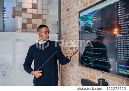 African American businessman delivers a compelling presentation of his business strategy to his colleagues, fostering collaboration and forward thinking African American businessman delivers a compelling presentation of his business strategy to his colleagues, fostering collaboration and forward thinking 132278523