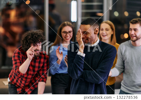 A group of young business people have fun playing interesting games while taking a break from work in a modern office. Selective focus A group of young business people have fun playing interesting games while taking a break from work in a modern office. Selective focus 132278536