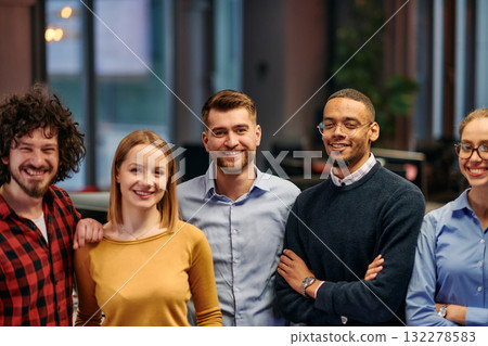 Portrait of successful creative business team looking at camera and smiling. Diverse business people standing together at startup. Selective focus Portrait of successful creative business team looking at camera and smiling. Diverse business people standing together at startup. Selective focus 132278583