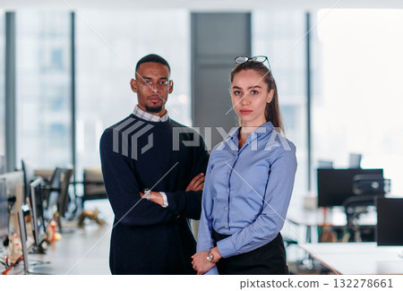 Dynamic Business Collaboration: Blonde Businesswoman and African American Colleague in Modern Office Setting. 132278661