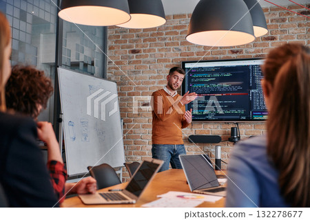 In a corporate setting businessman leads a meeting, passionately presenting a business plan to his attentive team, fostering collaboration and strategic thinking In a corporate setting businessman leads a meeting, passionately presenting a business plan to his attentive team, fostering collaboration and strategic thinking 132278677