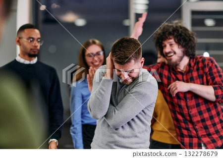 A group of young business people have fun playing interesting games while taking a break from work in a modern office. Selective focus A group of young business people have fun playing interesting games while taking a break from work in a modern office. Selective focus 132278679