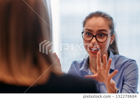Businesswoman Leading Discussion in Modern Office Setting 132278684