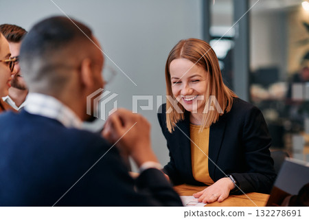 Businesswoman Leading Discussion in Modern Office Setting 132278691