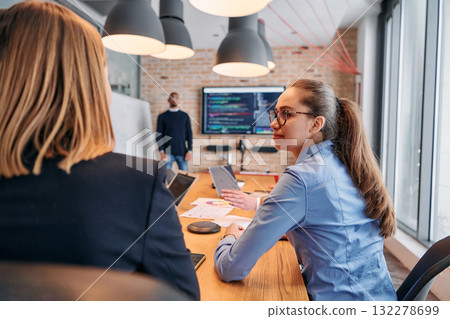 African-American businessman leads a meeting, passionately presenting a business plan to his attentive team, fostering collaboration and strategic thinking 132278699