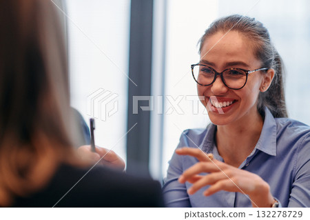 Businesswoman Leading Discussion in Modern Office Setting 132278729