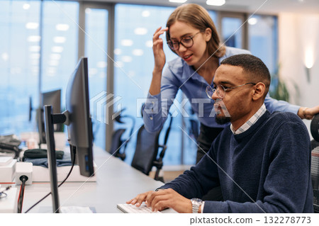 Digital Collaboration: Blonde Businesswoman and African American Partner Reviewing Documents Online Digital Collaboration: Blonde Businesswoman and African American Partner Reviewing Documents Online 132278773