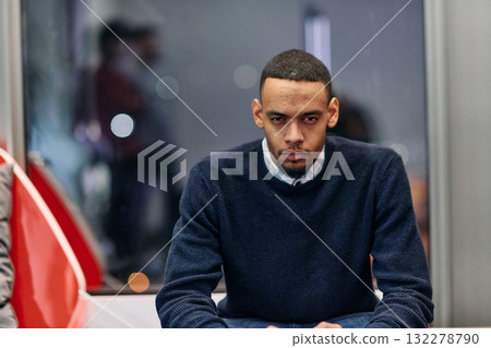 Young African American work in coworking space using smartphone analyzing online market trends, focused man worker reading financial news or browsing internet on phone. Technology concept 132278790