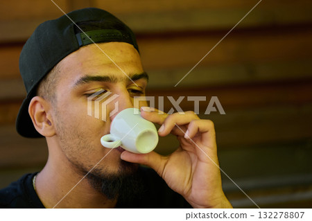 Close Up Portrait of Middle Eastern Teenager Enjoying a Coffee Close Up Portrait of Middle Eastern Teenager Enjoying a Coffee 132278807