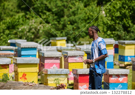 African American Teenager Exploring Small Beekeeping Businesses in Traditional Sudanese Attire amidst Nature 132278812