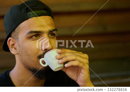 Close Up Portrait of Middle Eastern Teenager Enjoying a Coffee Close Up Portrait of Middle Eastern Teenager Enjoying a Coffee 132278816