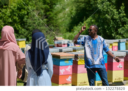 A diverse group of young friends and entrepreneurs explore small honey production businesses in the natural setting of the countryside. 132278820