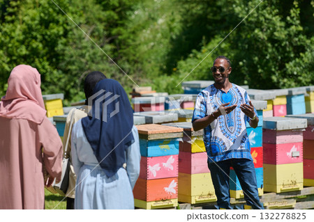 A diverse group of young friends and entrepreneurs explore small honey production businesses in the natural setting of the countryside. A diverse group of young friends and entrepreneurs explore small honey production businesses in the natural setting of the countryside. 132278825