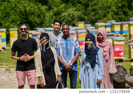 A diverse group of young friends and entrepreneurs explore small honey production businesses in the natural setting of the countryside. 132278848