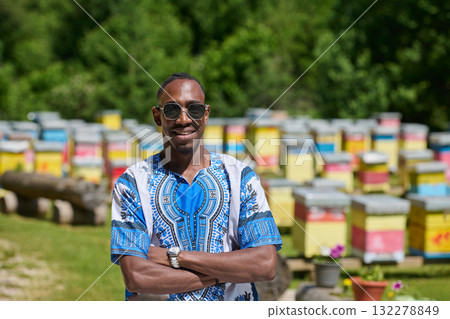African American Teenager Exploring Small Beekeeping Businesses in Traditional Sudanese Attire amidst Nature 132278849