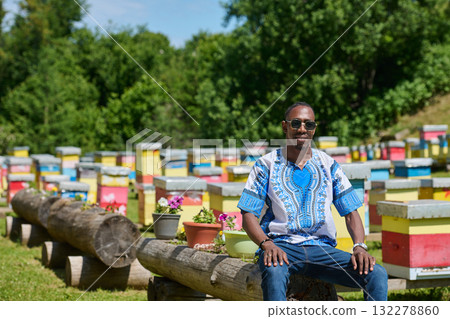 African American Teenager Exploring Small Beekeeping Businesses in Traditional Sudanese Attire amidst Nature African American Teenager Exploring Small Beekeeping Businesses in Traditional Sudanese Attire amidst Nature 132278860