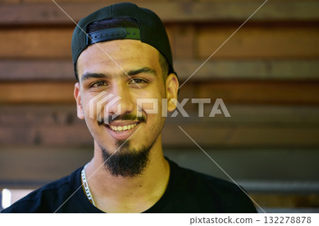 Close Up Portrait of Smiling Sudanese Teenager with Broad Smile, Chin, and Cap 132278878