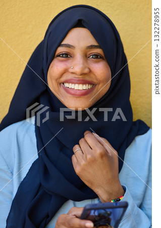Digital Connection: Close-up Portrait of a Middle Eastern Teenage Muslim Girl Using Smartphone Digital Connection: Close-up Portrait of a Middle Eastern Teenage Muslim Girl Using Smartphone 132278955