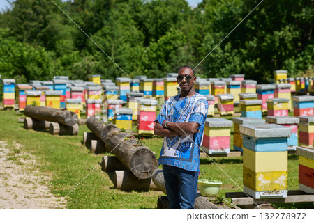 African American Teenager Exploring Small Beekeeping Businesses in Traditional Sudanese Attire amidst Nature 132278972