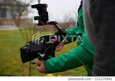 Videography team setting up the professional equipment and cameras for a high-quality music video shoot. Videography team setting up the professional equipment and cameras for a high-quality music video shoot. 132278982