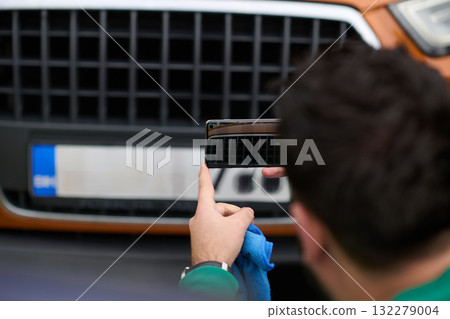 Capturing the Moment: A Man Photographs His Car for Sale to Share Online 132279004