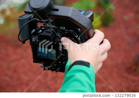 Videography team setting up the professional equipment and cameras for a high-quality music video shoot. 132279016