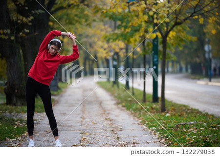 Athletic young woman taking a breath and relaxing after jogging and stretching. Woman Training and Workout Exercises On Street. 132279038