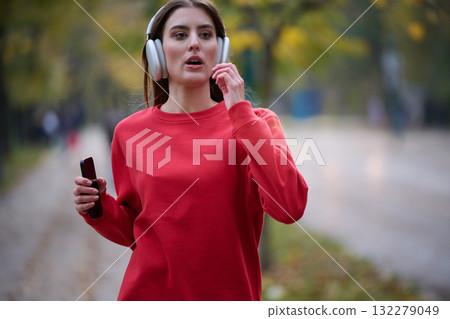 Athletic young woman taking a breath and relaxing after jogging and stretching. Woman Training and Workout Exercises On Street. 132279049