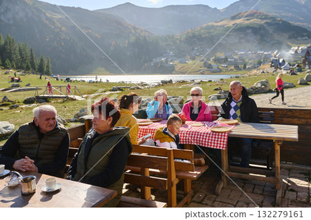 A group of senior friends engages in lively conversation with the waitress, discussing their meal preferences and savoring the delightful camaraderie that accompanies their dining experience 132279161