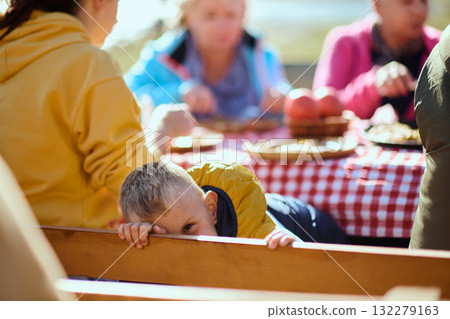 A family on a mountain vacation indulges in the pleasures of a healthy life, savoring traditional pie while surrounded by the breathtaking beauty of nature, fostering family bonds and embracing the A family on a mountain vacation indulges in the pleasures of a healthy life, savoring traditional pie while surrounded by the breathtaking beauty of nature, fostering family bonds and embracing the 132279163
