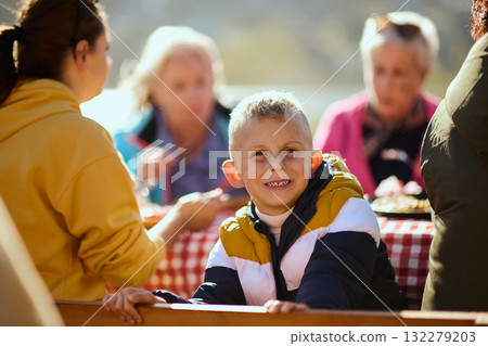 A family on a mountain vacation indulges in the pleasures of a healthy life, savoring traditional pie while surrounded by the breathtaking beauty of nature, fostering family bonds and embracing the A family on a mountain vacation indulges in the pleasures of a healthy life, savoring traditional pie while surrounded by the breathtaking beauty of nature, fostering family bonds and embracing the 132279203