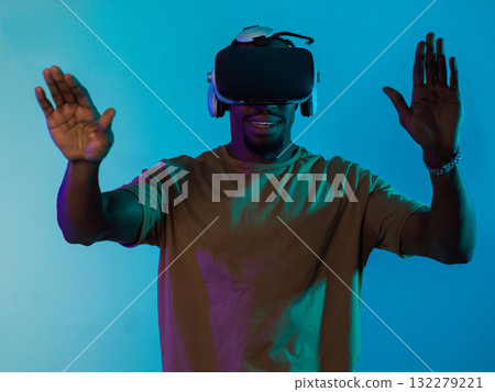 Immersed in a digital realm, an African American man navigates the virtual landscape with a VR goggles, using tactile gestures to interact with virtual objects, showcasing a harmonious blend of 132279221