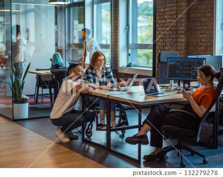 A diverse group of young business individuals congregates in a modern startup coworking center, embodying collaborative innovation and a dynamic atmosphere A diverse group of young business individuals congregates in a modern startup coworking center, embodying collaborative innovation and a dynamic atmosphere 132279278