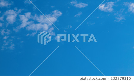 White cirrus clouds on blue sky. Fluffy clouds in summer sunny day. Nature cloudscape background with copy space. 132279310