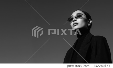 A fashionable portrait of a woman that emphasizes the aesthetics of shadow and form 132280134