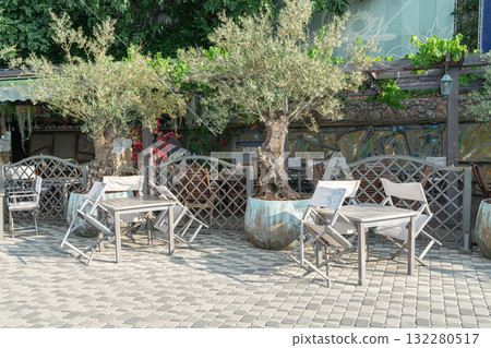 Charming Outdoor Dining Area With Rustic Furniture and Greenery Charming Outdoor Dining Area With Rustic Furniture and Greenery 132280517