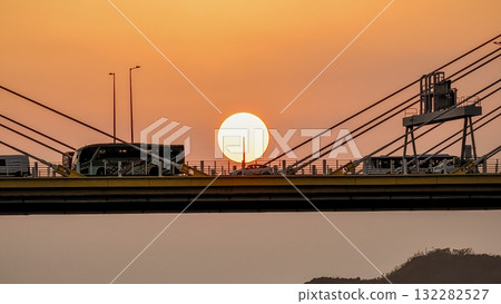 Oct 7 2025 Sunset Over Cable Bridge At Dusk With Warm Orange Sky And Silhouetted Structures Oct 7 2025 Sunset Over Cable Bridge At Dusk With Warm Orange Sky And Silhouetted Structures 132282527
