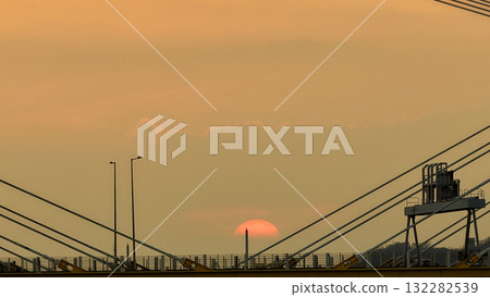Oct 7 2025 Sunset Over Cable-Stayed Bridge At Dusk With Aircraft Silhouette Oct 7 2025 Sunset Over Cable-Stayed Bridge At Dusk With Aircraft Silhouette 132282539