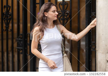 Young woman dials intercom code 132282558