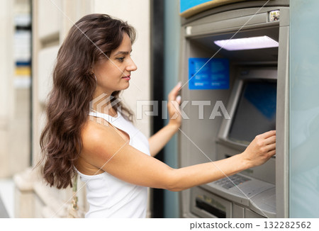 Young woman enters her ATM PIN code 132282562