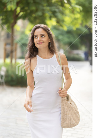 Young woman walks in city park 132282580
