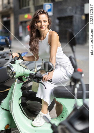 Young woman rents bike on city street 132282587