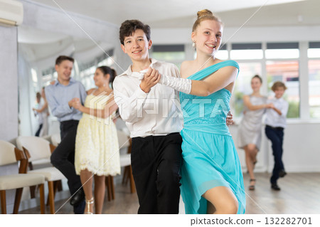 Teen boy and girl are dancing contemporary modern discofox in couple during lesson at studio Teen boy and girl are dancing contemporary modern discofox in couple during lesson at studio 132282701