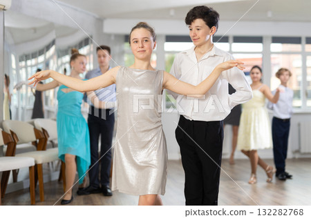Pair dances - girls and guys in festive attire dance tango or samba in studio Pair dances - girls and guys in festive attire dance tango or samba in studio 132282768