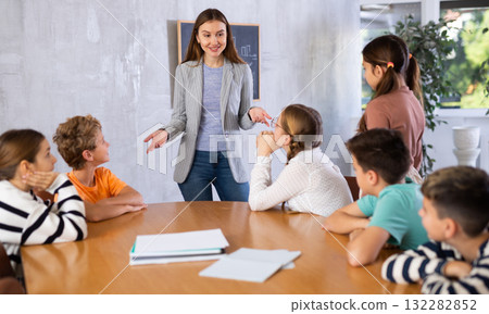 Portrait of female teacher giving lesson to children in school class Portrait of female teacher giving lesson to children in school class 132282852