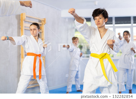 Group of children train karate techniques 132282854