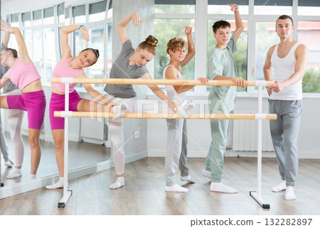 Teenage boys and girls posing with ballet-master in dancehall 132282897