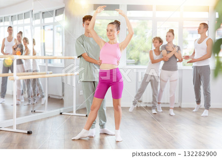 Boy and girl in pair train to perform ballet dance during rehearsal in studio 132282900