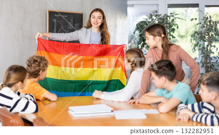 Teacher showing transgender flag to group of schoolchildren Teacher showing transgender flag to group of schoolchildren 132282951
