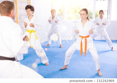 Group of children train karate techniques 132282969